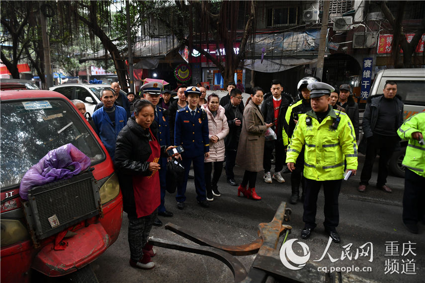 南坪正街聯合執法分隊對佔道僵尸車進行拖車處理 郭旭 攝