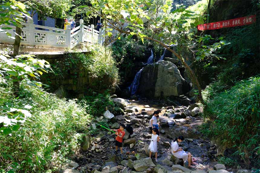 7月10日，孩子们在南山清水溪戏水玩耍，尽享清凉。郭旭摄