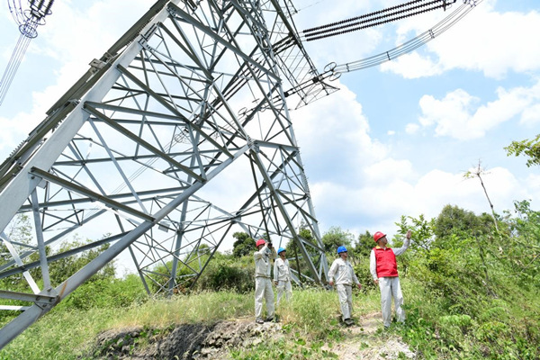 国网江津区供电公司员工对重要输电线路铁塔周边的防火情况进行巡查。王化全摄
