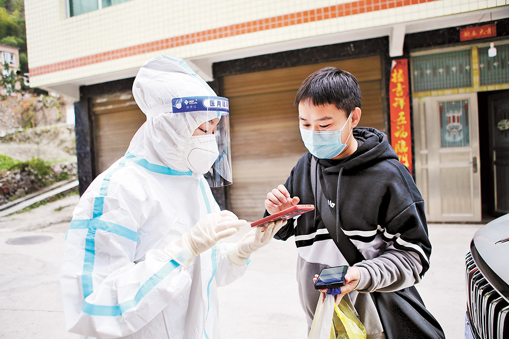 11月17日，黔江区城西街道，“95后”大学生西部计划志愿者罗双英(左)在迎宾社区录入居家隔离市民的信息。特约摄影 杨敏视觉重庆