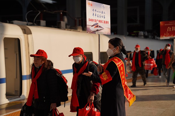 重庆西站工作人员引导外出务工人员有序上车。魏伟摄
