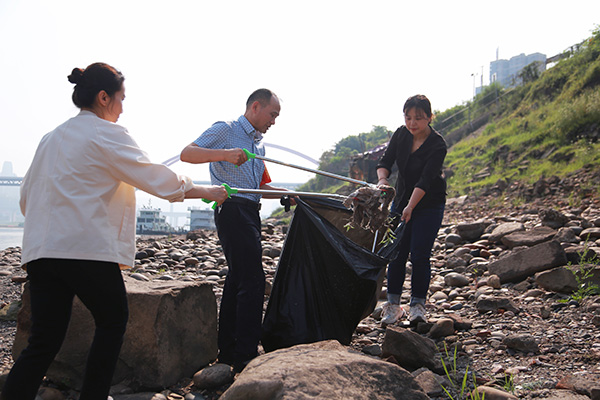 巡护人员沿江岸清理消落带垃圾。唐文蕤摄