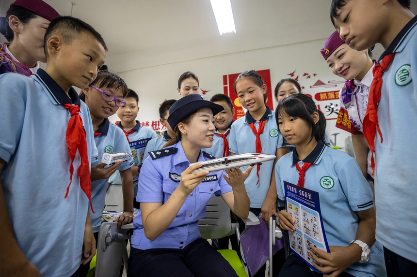 在重庆科学城含谷中学校多功能教室,民警和铁路职工向学生讲解铁路安全知识。李文航摄
