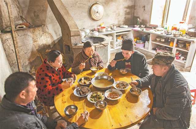 1月25日，万州区长滩镇太白溪村，佘中华一家在重建房屋内午餐。