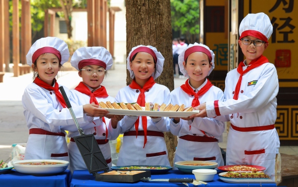 學生正在展示他們親手烹飪的美食。渝北區空港新城小學校供圖