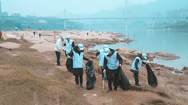 组织员工沿江岸捡拾垃圾。浦发银行重庆分行供图