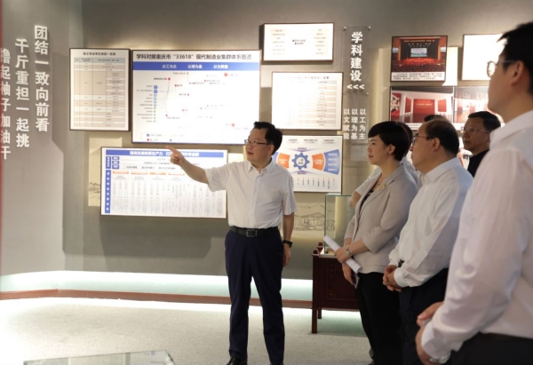 重庆理工大学党委书记康骞为嘉宾介绍校史馆。重庆理工大学供图