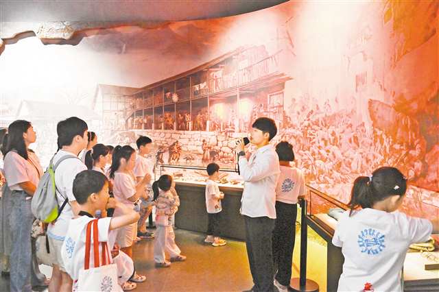 7月4日，沙坪壩區歌樂山革命紀念館，游客們在聆聽講解。特約攝影 孫凱芳/視覺重慶