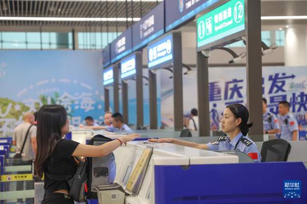 　7月8日，在重庆江北国际机场，重庆出入境边防检查总站民警查验旅客信息。新华社记者 黄伟 摄