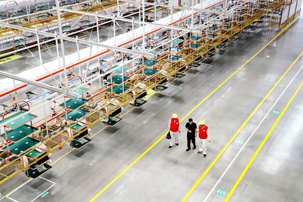 國網永川供電公司員工在雅迪集團重慶永川電動車生產基地了解客戶用電情況。林熙熙攝