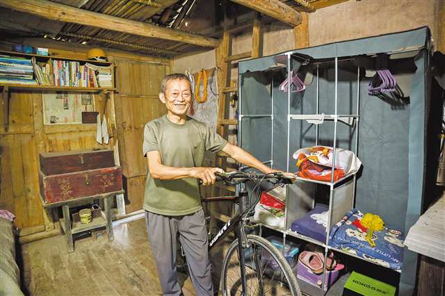 9月27日，彭水縣龍射鎮銀木村，汪付合展示1996年為兒子買的全村第一輛山地變速自行車。