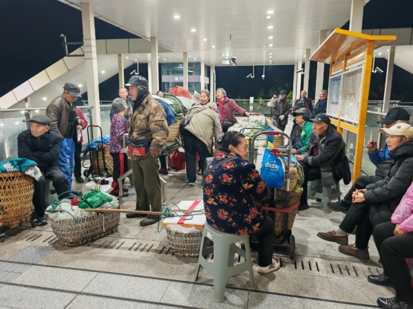 乘客坐在凳子上等候車站開啟運營。重慶軌道四號線公司供圖