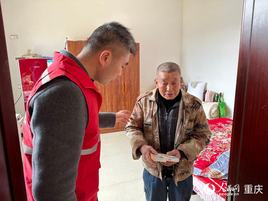 龙学洪(左)将药品送至傅廷志家中。人民网记者 刘政宁摄