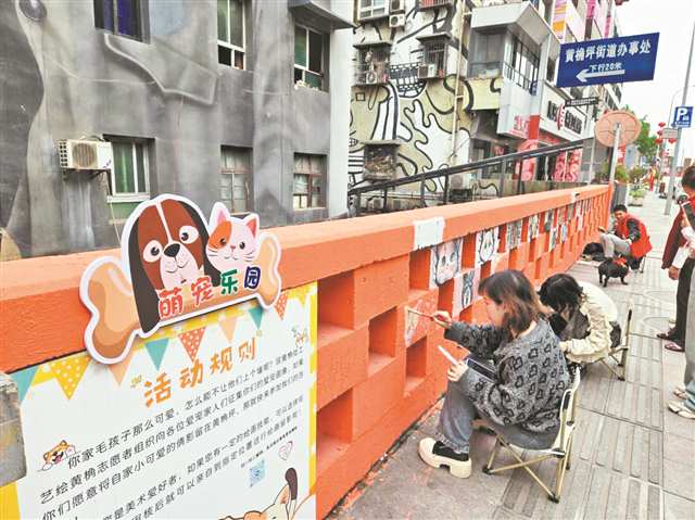 “藝繪黃桷”項目志願者在萌寵樂園進行涂鴉創作。