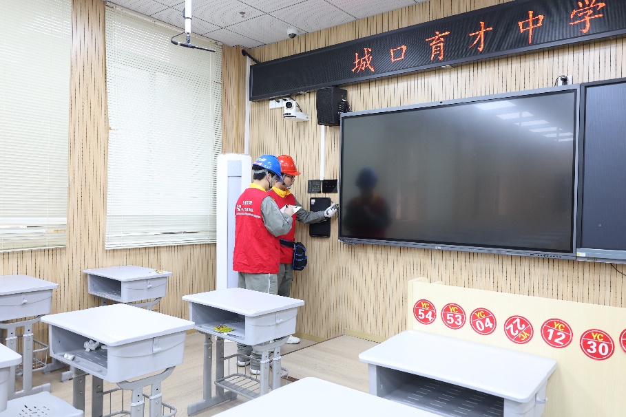 党员服务队队员对学校考室进行线路安全检查。邓芝华摄