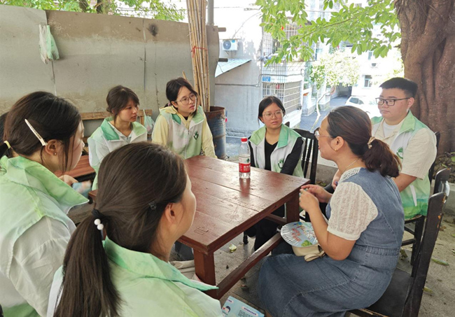 志愿者们与杨寺村卫生室村医围坐交谈。钱树平摄