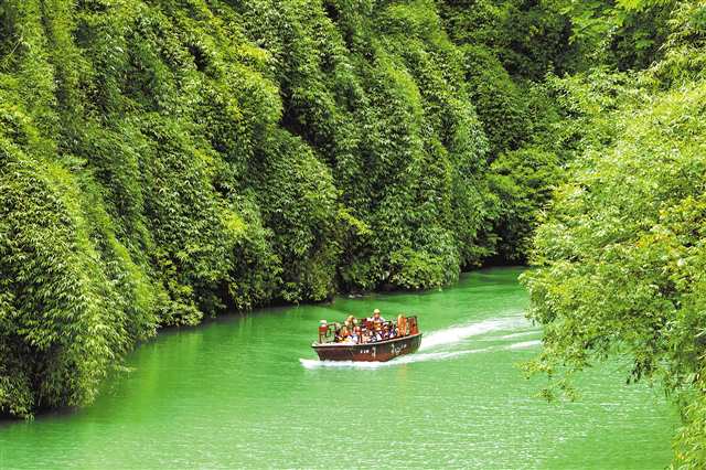 7月10日，游客在黔江区濯水景区乘坐旅游船穿越蒲花暗河，避暑纳凉（无人机照片）。特约摄影 杨敏/视觉重庆