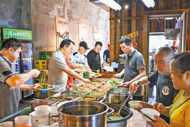 7月23日，位于两江新区红土地洞穴群的山城记忆·地下之城社区食堂，市民在选择菜品。记者 谢智强 摄/视觉重庆