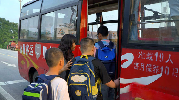学生在护学人员的引导下有序上车。铜梁区委宣传部供图